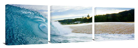 An ocean wave breaking onto the beach on the north shore.